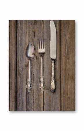 Vintage silverware on rustic wooden background table