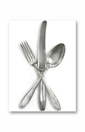 Vintage cutlery, silverware. Old silver cutlery, isolated on white background. Top view of table knife, fork and spoon with ornament details.