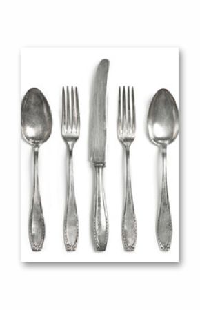 Vintage cutlery, silverware. Old silver cutlery, isolated on white background. Top view of table knife, fork and spoon with ornament details.