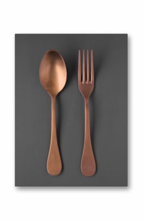 overhead shot of copper fork and spoon isolated on gray background