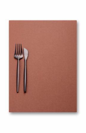 Knife and fork, cutlery on a brown dining table