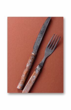 Knife and fork, cutlery on a brown dining table