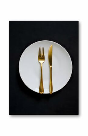 A minimalist white plate with golden cutlery on a black background   -
