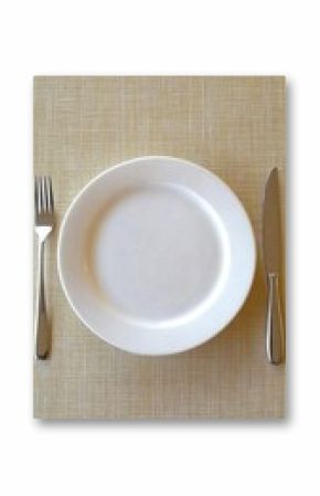 A pristine white dinner plate, fork, and knife arranged on a pale yellow textured tablecloth, viewed from above