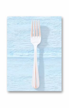 White Plastic Fork on Blue Wood Surface