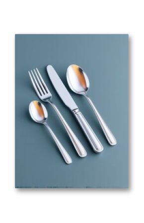 Silver Cutlery Set on Teal Background