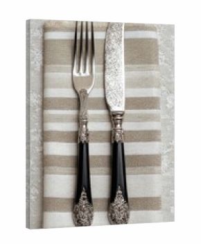Elegant silverware atop a striped napkin