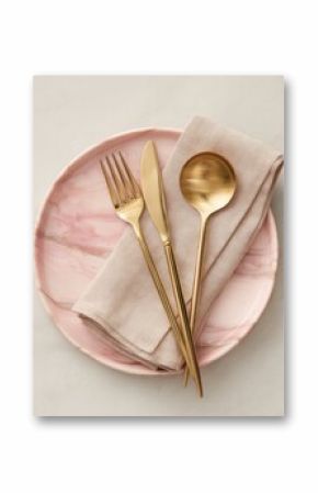 A pink marble plate holds gold cutlery and a beige napkin  elegant place setting, overhead view