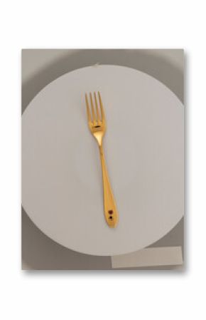 Golden fork with red gemstone accents on white circular surface cutlery utensil