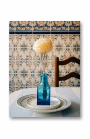 Creative Display of Food on a Fork and Bottle in Dining Setting