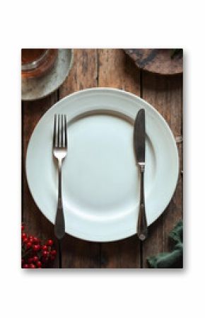 Empty white plate with fork and knife on rustic wooden table, vintage cutlery and food background for restaurant menu, cooking concept, diet template, copy space for text or culinary design