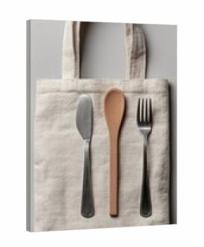 Beige canvas tote bag with metal cutlery and wooden spoon