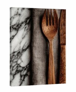 Wooden cutlery set on a linen napkin, marble surface