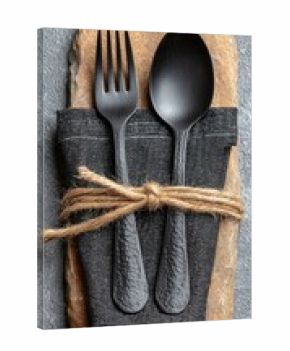 Black cutlery, napkin, and stone placemat