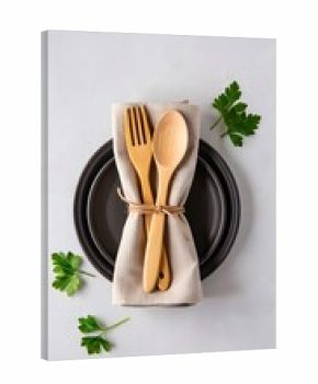 Table setting with wooden cutlery on a plate and napkin with parsley garnish decor