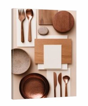 Elevated flatlay of copper-toned and wood tableware, showcasing minimalist design elements on a beige background