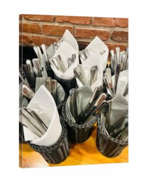 Catering background. Multiple buckets filled with arranged cutlery and folded napkins are displayed in an organized manner