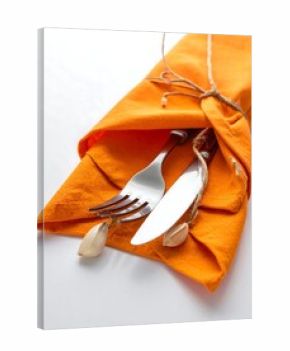 Orange napkin with cutlery and decorative elements