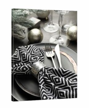 Christmas setting with plates, napkin, cutlery and festive decor on grey table, closeup