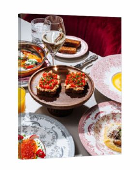 Assorted gourmet brunch dishes with wine and juice