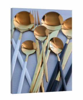 Golden cutlery on blue background