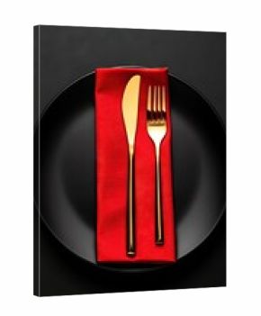 Elegant luxury table setting with red napkin and golden cutlery on black plate creating a sophisticated dining atmosphere