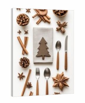 A beautifully arranged Christmas table features a grey plate with a napkin folded into a Christmas tree, complemented by silverware