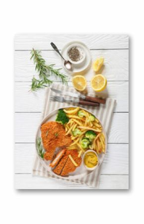 breaded pork cutlet with fries, broccoli on plate