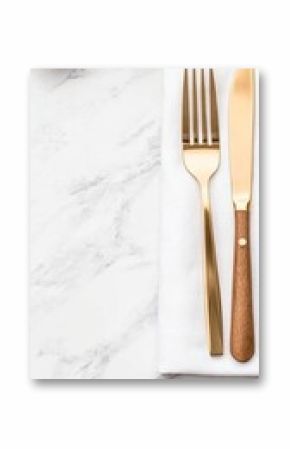 A beautifully arranged set of gold cutlery is elegantly placed alongside a grey linen napkin on a marble surface, ideal for dining