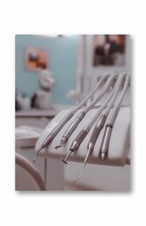 Dental instruments on a tray in a modern dental clinic, ready for use.  Clean, sterile tools ensure a safe patient experience.