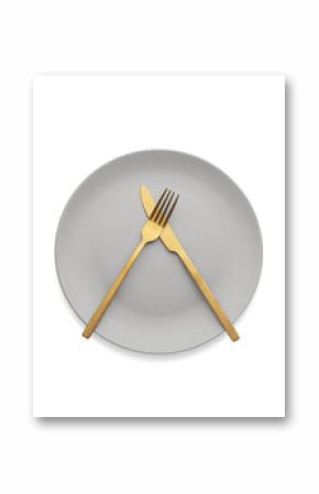 White plate with gold cutlery on the table