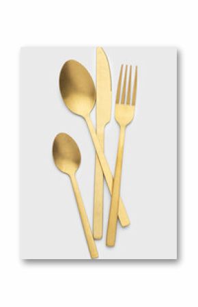 Set of golden metal cutlery on white background