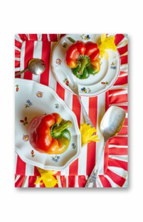 Bell peppers on plates with flowers and cutlery