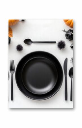 Elegant black dinnerware with cutlery and pumpkins for halloween table setting