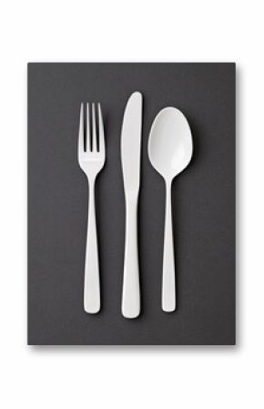 Elegant white cutlery set including fork, knife, and spoon on a dark textured background
