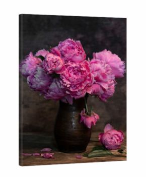 Beautiful bouquet of pink peonies in vase on a wooden table
