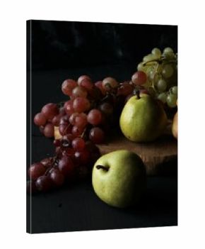 fruits, grapes, pears on a black background