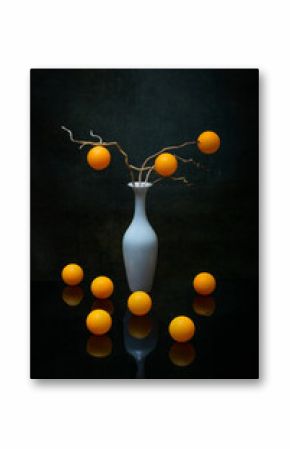 Still life with orange balls in a white vase