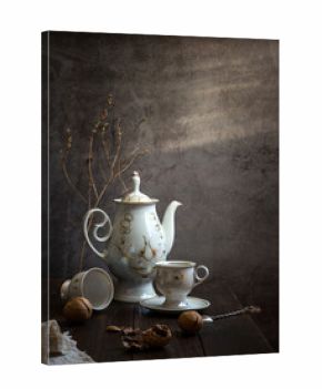 Modern still life with coffee pot, cup and walnuts
