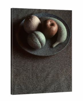 Granite-like sculpture of fruit on a plate