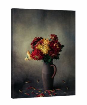still life decorative red and yellow flowers  in old ceramic vase on canvas  background natural light