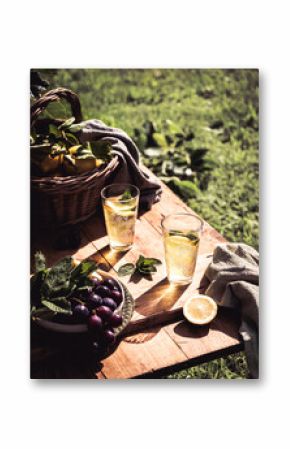 Refreshing lemonade in garden setting with summer fruits