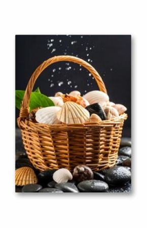 Wicker Basket Overflowing with Seashells and a Green Leaf on Wet Black Stones