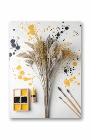 Dried pampas grass and art supplies are arranged on a white background