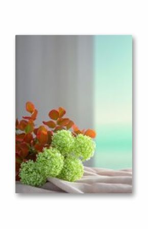 Closeup of Red and Green Flowers on Beige Fabric Near Window