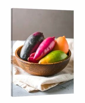 Colorful fruits in wooden bowl