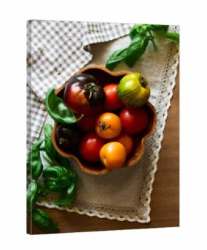 Multicolored tomatoes on the table top view indoors in autumn