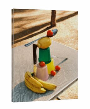 Creative fruit and utensil arrangement on a table outdoors