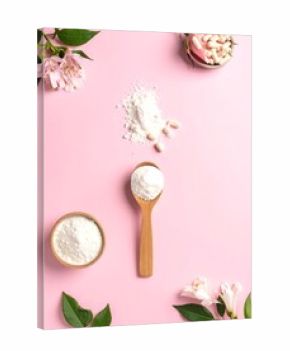 Still life of supplements, flowers, and powder on a pink backdrop