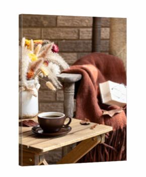 Cup of coffee on wooden table outdoors on porch